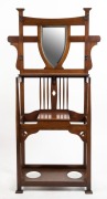 An Australian Arts & Crafts Queensland maple hallstand with shield shaped mirror, early 20th century, 191cm high, 100cm wide, 30cm deep
