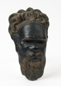 An Aboriginal face plaque, painted chalkware, mid 20th century, 23cm high