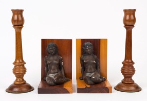 A pair of Australiana bookends with Aboriginal figures together with a pair of turned blackwood candlesticks, 20th century (4 items), the 23cm and 14cm high