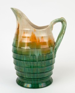 REMUED early series green and cream glazed pottery jug with brown and yellow highlights, incised "Remued", 25cm high