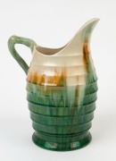 REMUED early series green and cream glazed pottery jug with brown and yellow highlights, incised "Remued", 25cm high - 2