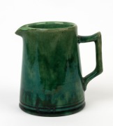McHUGH green glazed pottery cream jug, incised "McHugh, Tasmania,&nbsp;&frac12; PT", 10cm high