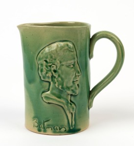 REMUED "Batman, Melbourne Centenary" green glazed pottery jug with profile portrait, incised "Remued", 12.5cm high