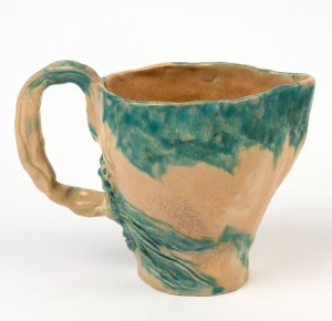 Hand-built pottery jug with applied gumnuts and leaves in the style of Jolliff, incised "Hand Built, MAG, 1942", 12cm high, 17cm wide