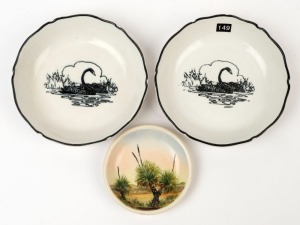 A pair of black swan porcelain dishes together with a hand-painted porcelain pin tray titled "Black Boys Trees, Perth, W.A, Alva", (3 items), 12.5cm and 8.5cm diameter 