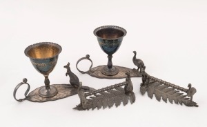 A pair of silver plated Australian eggcups, together with a pair of knife rests, 19th century, (4 items), the eggcups 7.5cm high