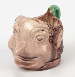 ARTIST UNKNOWN Australian pottery character jug, signed and inscribed on the base (illegible), 11cm high, 16cm wide