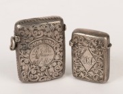 VESTA CASES: Two antique English sterling silver examples, the large hallmarked "W.N." for William Neale, Chester 1894; the smaller hallmarked for William Henry Leather, Birmingham, 1897; the larger 5cm high, 4cm wide.  - 2