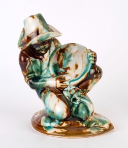 HUNTLY POTTERY gold miner statue with mottled glaze, stamped "Huntly Pottery", 19cm high