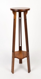 An Australian Arts & Crafts blackwood tri-form pedestal with circular top, early 20th century, 109cm high, 30cm diameter