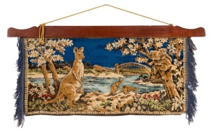 SYDNEY HARBOUR BRIDGE: An Australian woven wall-hanging featuring the newly completed Sydney Harbour Bridge, kangaroos, koalas, trees and flowers; the scene suspended from a timber beam which is, in turn, suspended from a yellow silk rope. the image is 44