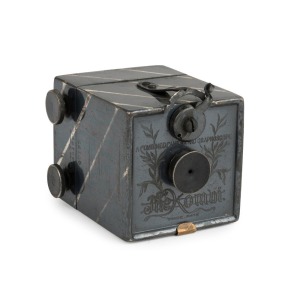 KEMPER (U.S.A.): Kombi, metal miniature box camera [#42177] with oxidized silver finish, introduced in 1892. Made to take 25 exposures on rollfilm, then double as a transparency viewer. Complete, with lens cap and original box. N.B: Additional lens cap wi