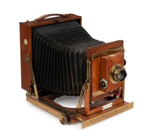 Thornton-Pickard: New Imperial Triple Extension half plate field camera, mahogany with brass trim and strips above and below rollerblind shutter, with leather bellows, circa 1910, with Aldis Anastigmat f7.7 No. 7 lens.