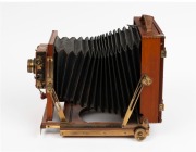 Thornton-Pickard: New Imperial Triple Extension half plate field camera, mahogany with brass trim and strips above and below rollerblind shutter, with leather bellows, circa 1910, with Aldis Anastigmat f7.7 No. 7 lens. - 2