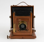 Thornton-Pickard: Amber compact folding view half plate camera (S 69305 impressed on base of shutter), circa 1899, brass bound lens and Harrington & Co., Sydney retailer's plate with additional plate "Harrington's Favorite Outfit" - 2