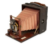 Rochester Optical Company: Pony premo No. 3 folding bed camera, circa 1905, with Bausch & Lomb "Victor" shutter and rectilinear lens. Original leather bellows. Double dark slide present. - 2