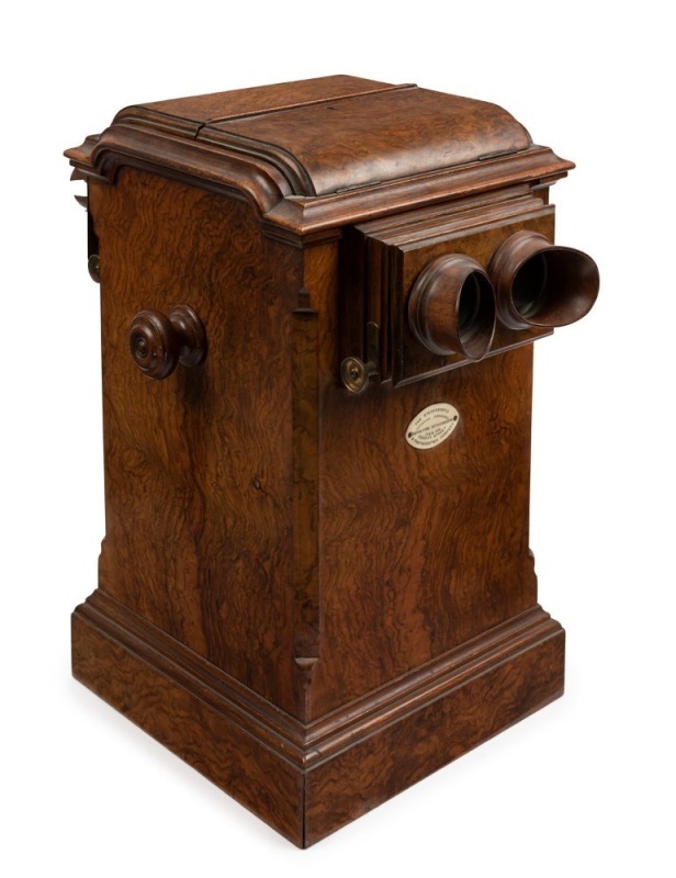 The Stereoscopic & Photographic Company (Regent Street, London): Revolving stereoscope table top stereo viewer in lovely walnut case with many cards present, circa 1895; 44cm high.