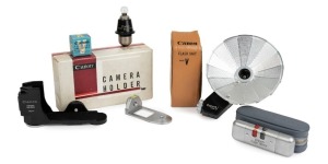 A Canon Camera Holder in original box; a Canon Flash Unit model V in leather case; a Canon Flash Tester  No.3498 in original pouch; a Canon Midget bulb adapter; and a Canon Parallax Compensator III in original box. (5 items).