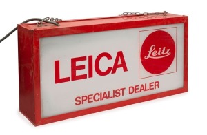 Vintage LEICA shop advertising sign: "LEICA Specialist Dealer" with LEITZ red dot on both sides; internally illuminated. 63cm wide; 30cm high; 15cm deep.