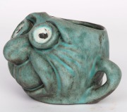 HENRY BOLTE&nbsp;pottery face mug by GUS & BETTY McLAREN&nbsp;of Warrandyte, Victoria, circa 1970s. Modeled after a work by the noted political cartoonist LES TANNER. Incised "Designed By Tanner", ​​​​​​​11cm high, 17cm wide - 3