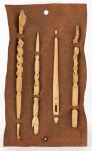 Set of four sailor's sewing tools, finely crafted in carved whalebone, 19th century, the largest 16cm long