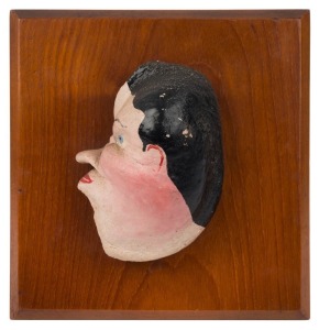 ARTIST UNKNOWN sailor's folk art wall mounted profile caricature plaque, hand-painted whale's eardrum, 19th century, ​​​​​​​13cm high, the wooden mount 20 x 19cm overall