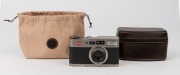 LEITZ: Leica Model CM 35mm point-and-shoot camera, 2004, [#2952002] with fixed Summarit f2.4 40mm lens and Leica brown leather carry case with strap. - 2