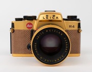 LEITZ: Leica R4 Gold [#1651925] pale brown snakeskin body cover and C157 number plate affixed on rear of body, 1984, with a gold and black special edition Summilux-R f4 50mm lens [#3295897]. Original felt-lined presentation timber case, box, paperwork and - 2