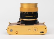 LEITZ: Leica R4 Gold [#1651925] pale brown snakeskin body cover and C157 number plate affixed on rear of body, 1984, with a gold and black special edition Summilux-R f4 50mm lens [#3295897]. Original felt-lined presentation timber case, box, paperwork and - 5