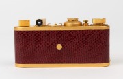 LEITZ: Leica "Luxus" Gold Plated Replica [#23355], red lizard skin body cover, fitted with Elmar f3.5 50mm lens and matching lens cap, with matching Leica leather ERC. - 3