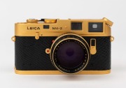 LEITZ Canada: Leica M4-2 Gold Plated Special Edition [#1528598], 1979, limited edition of 1000 to commemorate the birth of Oskar Barnack, with black and gold plate Summilux f4 50mm lens [#2980853]. The camera numbered 100-0573 on top plate. Original box i - 2