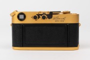 LEITZ Canada: Leica M4-2 Gold Plated Special Edition [#1528598], 1979, limited edition of 1000 to commemorate the birth of Oskar Barnack, with black and gold plate Summilux f4 50mm lens [#2980853]. The camera numbered 100-0573 on top plate. Original box i - 3