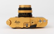 LEITZ Canada: Leica M4-2 Gold Plated Special Edition [#1528598], 1979, limited edition of 1000 to commemorate the birth of Oskar Barnack, with black and gold plate Summilux f4 50mm lens [#2980853]. The camera numbered 100-0573 on top plate. Original box i - 4