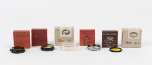 LEITZ: Group of 5 filters comprising POOTR polarisation filter, FIPOS No1 green, FIGRO No1 light yellow, FIGAM No2 yellow filter, HOOIV UVA and FIOLA UV (box only). All in original boxes. (5 filters; 6 boxes)