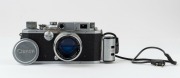 Canon Model IIS&nbsp;rangefinder camera, 1954-55 [#113277; model identified on loading diagram] with Canon f1.8 50mm lens [#105802] and self-extension adaptor; metal lens cap also present. - 2