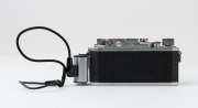 Canon Model IIS&nbsp;rangefinder camera, 1954-55 [#113277; model identified on loading diagram] with Canon f1.8 50mm lens [#105802] and self-extension adaptor; metal lens cap also present. - 3