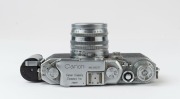 Canon Model IIS&nbsp;rangefinder camera, 1954-55 [#113277; model identified on loading diagram] with Canon f1.8 50mm lens [#105802] and self-extension adaptor; metal lens cap also present. - 4
