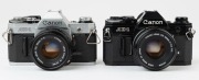 Canon AE-1 SLR cameras: one with black finish [#911428] and Canon FD 50mm f1.8 S.C. lens [#624787] and original box; the other with chrome finish [#1689930] with Canon FD 50mm f2 lens [#78999]. (2 cameras). - 2