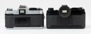 Canon AE-1 SLR cameras: one with black finish [#911428] and Canon FD 50mm f1.8 S.C. lens [#624787] and original box; the other with chrome finish [#1689930] with Canon FD 50mm f2 lens [#78999]. (2 cameras). - 3