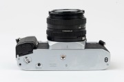 Canon AL-1 QF SLR camera, 1982 [#1097585] with Canon FD 50mm f1.8 lens [#5980840], the commemorative lens cap "OFFICIAL 35MM CAMERA * 1984 OLYMPIC GAMES". - 5