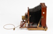Thornton-Pickard: New Imperial Triple Extension half plate field camera, mahogany with Brass trim and strips above and below Rollerblind shutter, with leather bellows, circa 1910, with Beck Symmetrical lens and original cable release. Baker and Rouse (Col - 4