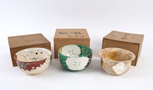 Three Japanese ceramic bowls all in original spruce boxes, the green and gold example 10.5cm high, 19.5cm diameter