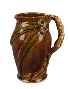 REMUED early pottery jug with applied gumnuts and leaves and branch handle, appears to be the work of Allan James, incised "Remued", 20cm high