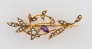 An antique 9ct yellow gold floral brooch set with amethyst and seed pearls, late 19th century, stamped "A.B. 9C", ​​​​​​​4.5cm wide, 2.7 grams