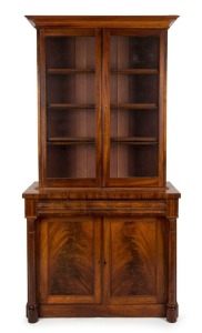 An early Colonial Australian cedar bookcase with fine flame panel doors, full turned columns and astragal glazed doors, huon pine secondary timbers, Tasmanian origin, circa 1830-1840, 205cm high, 102cm wide, 46cm deep