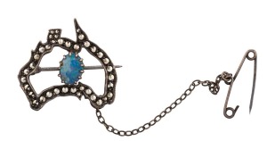 A vintage map of Australia sterling silver brooch set with an opal surrounded by marcasites, early 20th century, stamped "STG. STERLING", 3cm wide