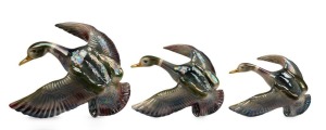 M.C.P. set of three ceramic flying ducks, Sydney origin, early to mid 20th century, the largest 33cm wide