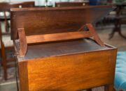 A Sheraton reading table, mahogany with ebony string inlay and bone escutcheon Finely crafted with tilting lid and original brass handles and castors, fitted accessory drawer to the right hand side, late 18th century. A rare and exceptional example. 74cm - 3