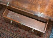 A Sheraton reading table, mahogany with ebony string inlay and bone escutcheon Finely crafted with tilting lid and original brass handles and castors, fitted accessory drawer to the right hand side, late 18th century. A rare and exceptional example. 74cm - 9