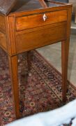 A Sheraton reading table, mahogany with ebony string inlay and bone escutcheon Finely crafted with tilting lid and original brass handles and castors, fitted accessory drawer to the right hand side, late 18th century. A rare and exceptional example. 74cm - 11